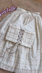 Metallic zari check lehenga paired with a embroidered halter neck crop blouse