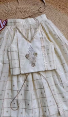 Metallic zari check lehenga paired with a embroidered halter neck crop blouse